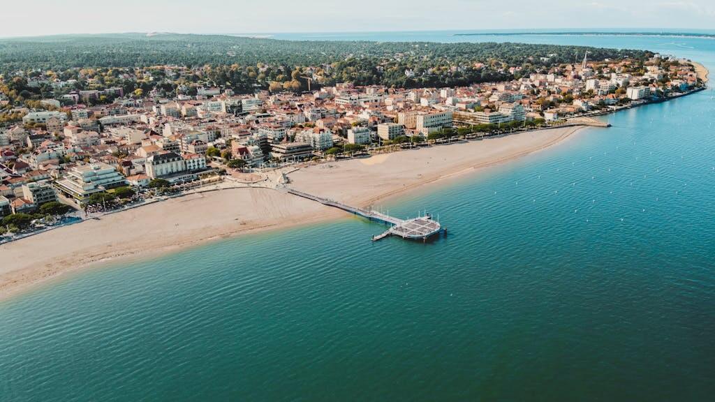 Scenic aerial view of Arcachon's beachfront and town, capturing the vibrant coastline of Nouvelle-Aquitaine, France.